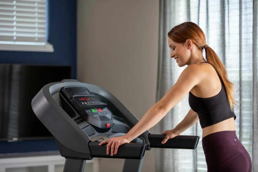 Female athlete training with strength machine in fitness center